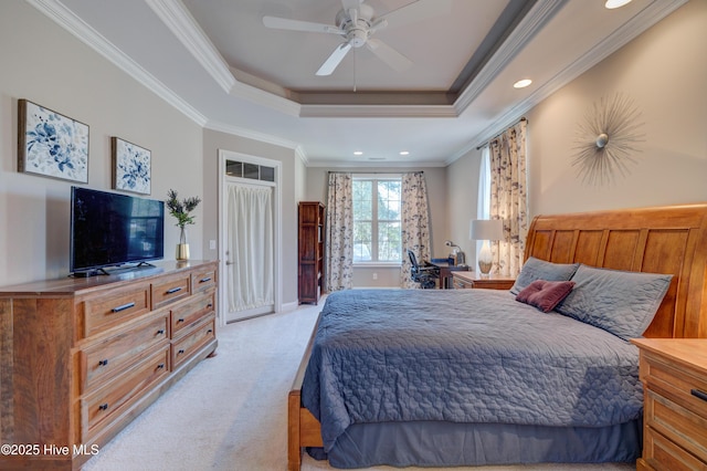 bedroom with a raised ceiling, ornamental molding, light colored carpet, and ceiling fan