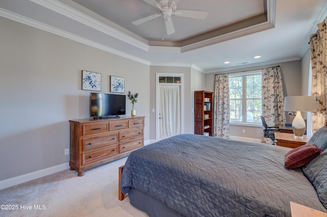 carpeted bedroom featuring crown molding, a raised ceiling, and ceiling fan