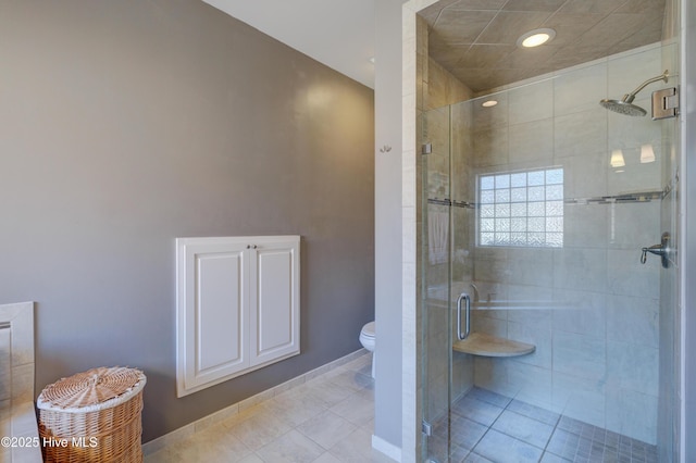 bathroom with walk in shower, toilet, and tile patterned flooring