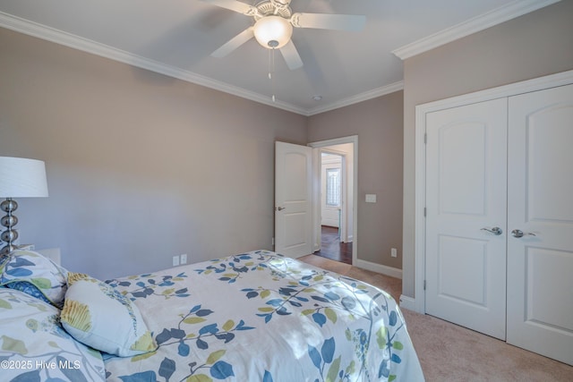 bedroom featuring crown molding, light carpet, ceiling fan, and a closet