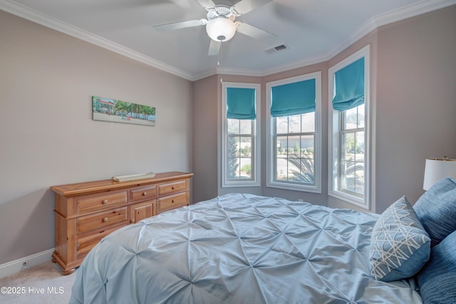 bedroom featuring ornamental molding, light colored carpet, and ceiling fan