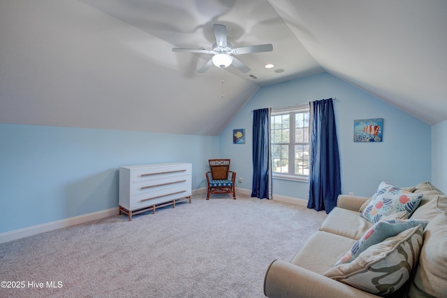 living area with ceiling fan, light colored carpet, and vaulted ceiling