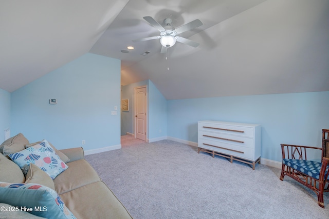 living area with vaulted ceiling, light colored carpet, and ceiling fan