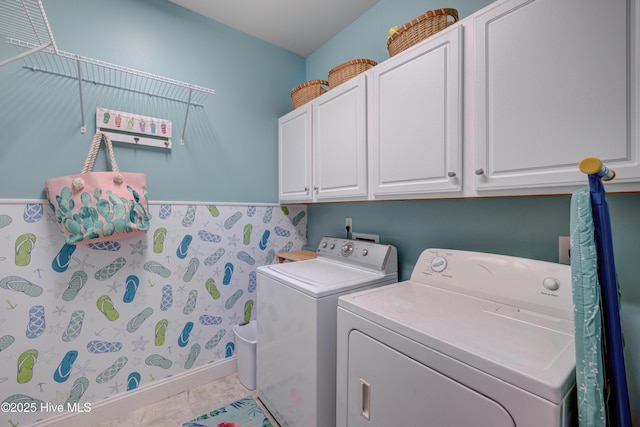 clothes washing area with cabinets, separate washer and dryer, and light tile patterned floors