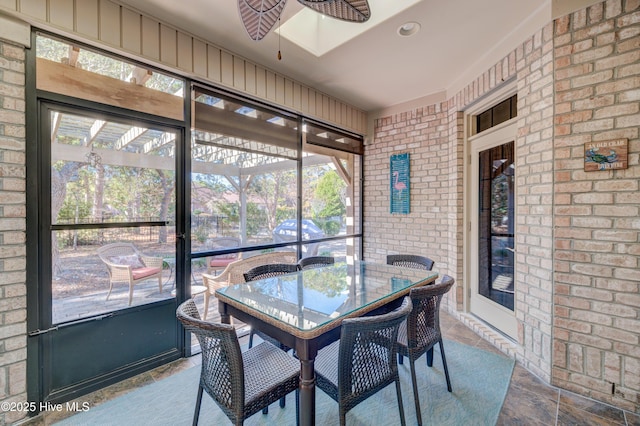 sunroom / solarium featuring ceiling fan