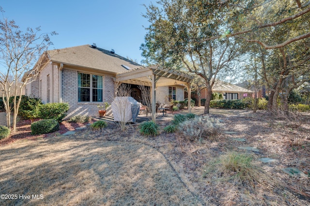 back of house with a pergola and a patio