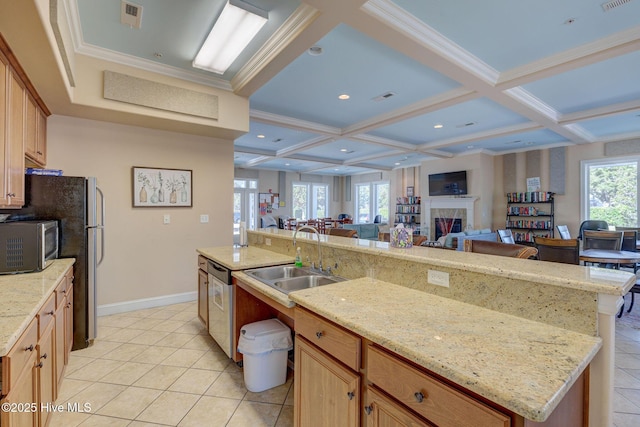 kitchen featuring appliances with stainless steel finishes, sink, coffered ceiling, a kitchen island with sink, and a healthy amount of sunlight