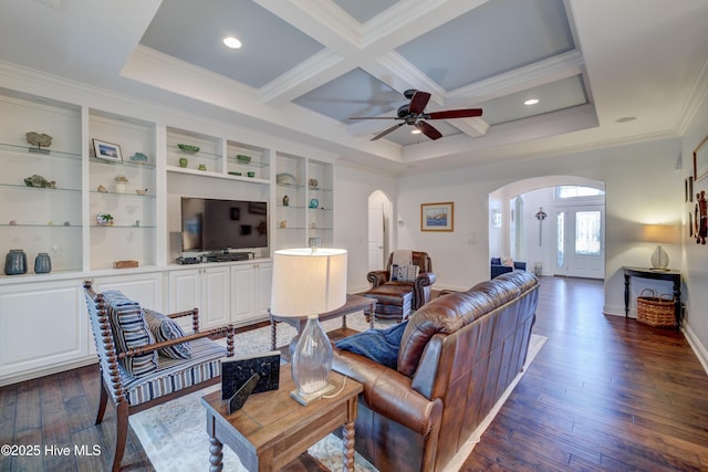 living room featuring crown molding, coffered ceiling, dark wood-type flooring, and beam ceiling