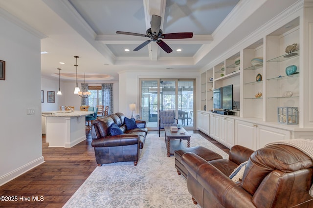 living room with beamed ceiling, ornamental molding, dark hardwood / wood-style floors, and a wealth of natural light