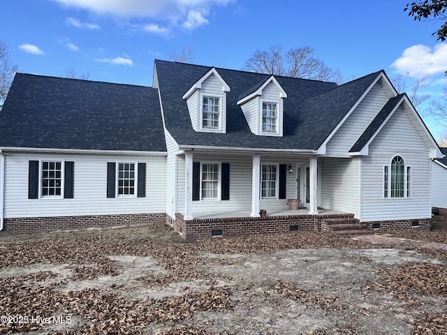 cape cod house with crawl space, a porch, and roof with shingles