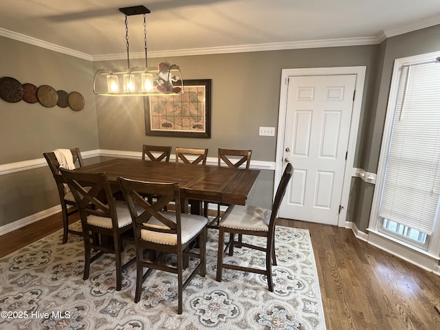 dining area featuring hardwood / wood-style floors, a notable chandelier, and crown molding