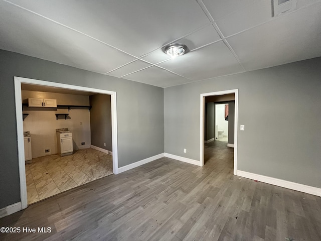 interior space featuring wood finished floors, visible vents, and baseboards