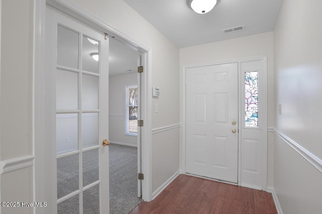 foyer featuring wood-type flooring and a wealth of natural light