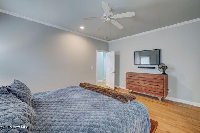 bedroom with ceiling fan, ornamental molding, and hardwood / wood-style flooring