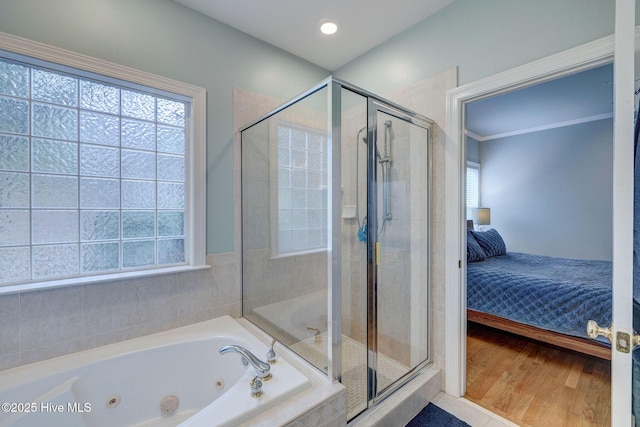 bathroom with hardwood / wood-style flooring and independent shower and bath