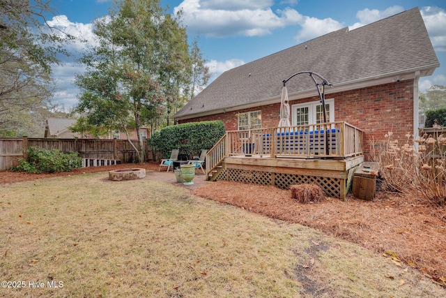 view of yard with a fire pit and a deck