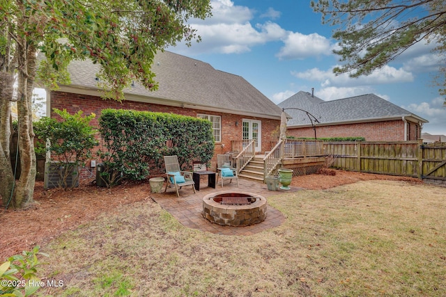 view of yard with a wooden deck and a fire pit