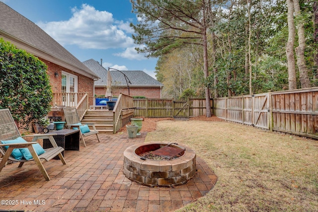 view of patio featuring a fire pit and a deck