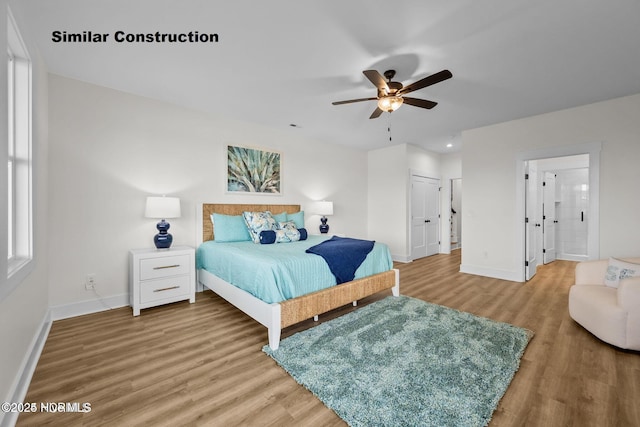 bedroom with connected bathroom, a closet, ceiling fan, and hardwood / wood-style floors