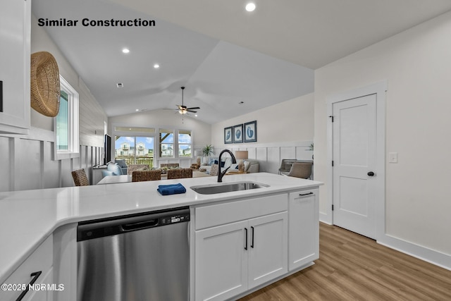 kitchen featuring white cabinetry, sink, ceiling fan, stainless steel dishwasher, and lofted ceiling