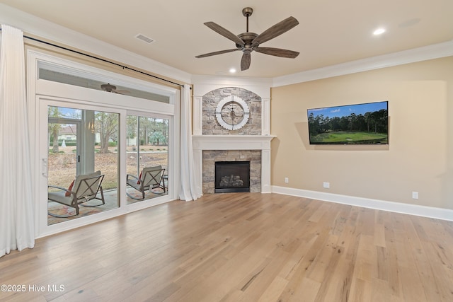 unfurnished living room with a fireplace, light hardwood / wood-style flooring, ceiling fan, and ornamental molding