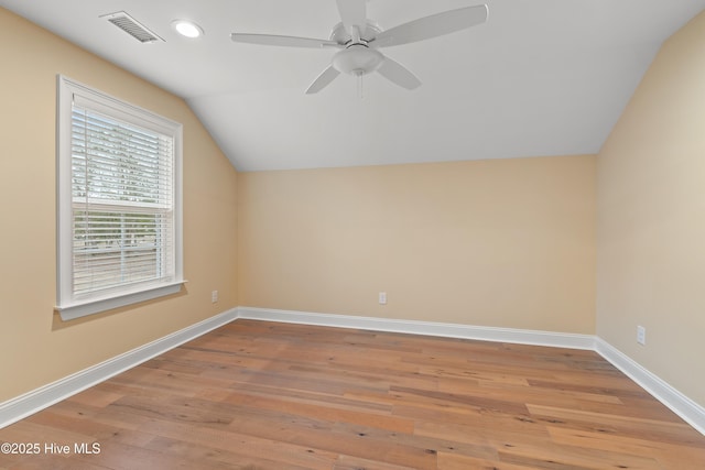 additional living space with ceiling fan, light hardwood / wood-style floors, and vaulted ceiling