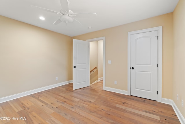 unfurnished bedroom with ceiling fan and light hardwood / wood-style flooring