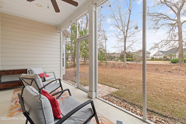 sunroom featuring ceiling fan