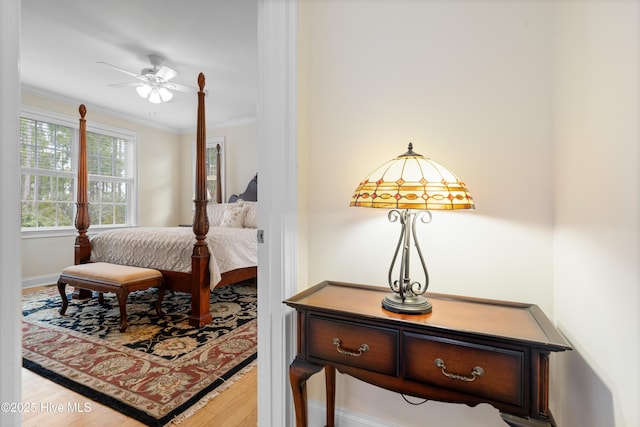 bedroom with hardwood / wood-style floors and crown molding