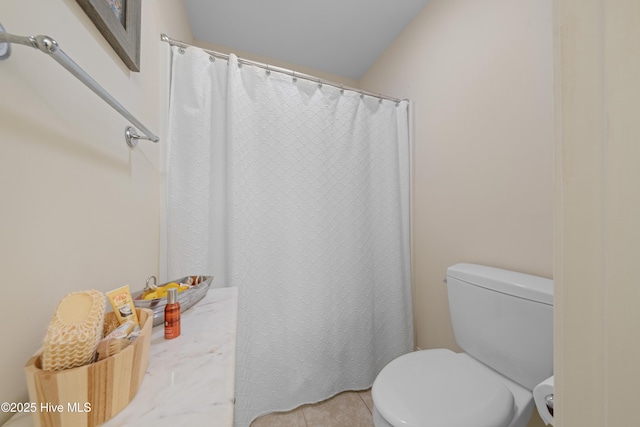 bathroom with tile patterned flooring, vanity, and toilet