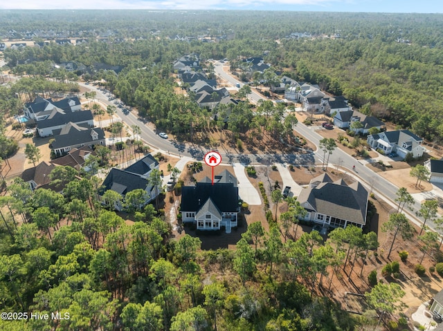birds eye view of property with a wooded view and a residential view