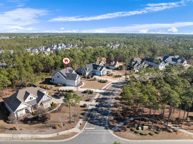 drone / aerial view with a forest view and a residential view