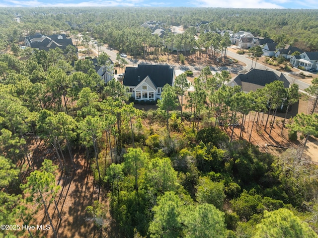 aerial view featuring a residential view and a wooded view