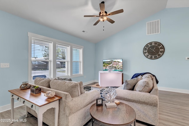 living room featuring hardwood / wood-style floors, ceiling fan, and lofted ceiling