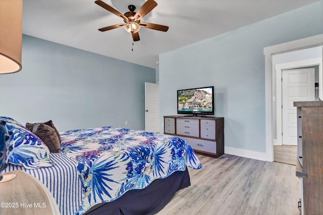 bedroom with ceiling fan and light hardwood / wood-style flooring