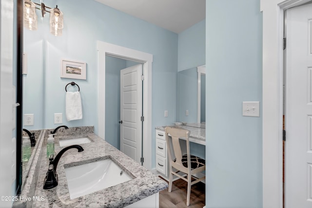 bathroom with hardwood / wood-style floors and vanity