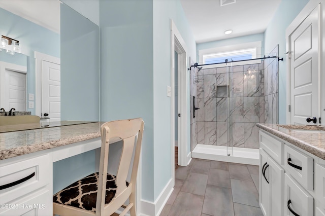 bathroom with a shower with door and vanity