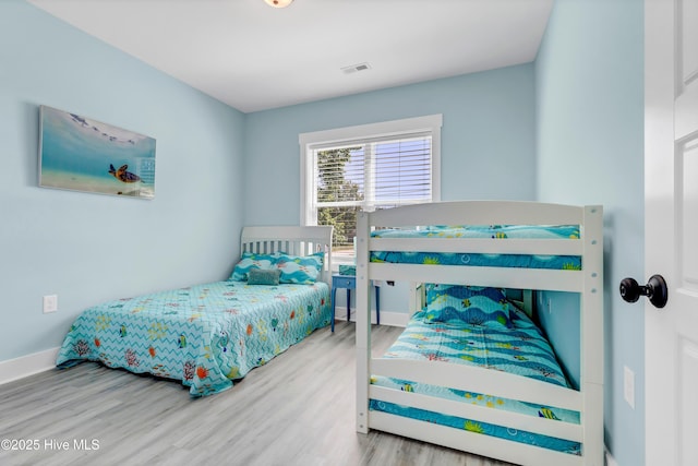 bedroom with hardwood / wood-style flooring