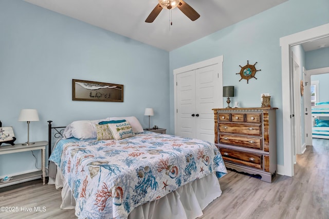 bedroom featuring ceiling fan, a closet, and light hardwood / wood-style floors