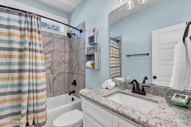 full bathroom featuring vanity, shower / tub combo, and toilet