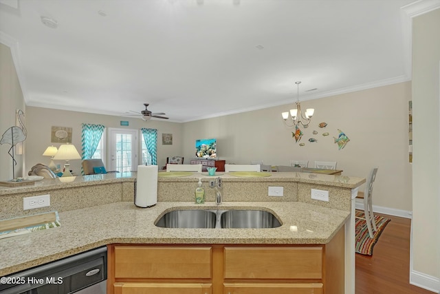 kitchen with hardwood / wood-style floors, dishwasher, crown molding, sink, and light stone countertops