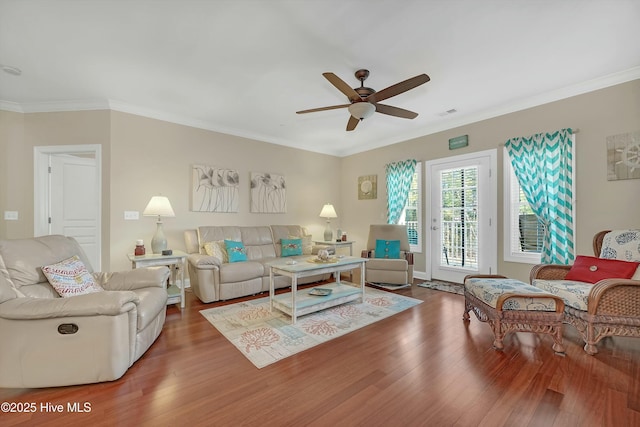 living room with hardwood / wood-style floors, ceiling fan, and crown molding