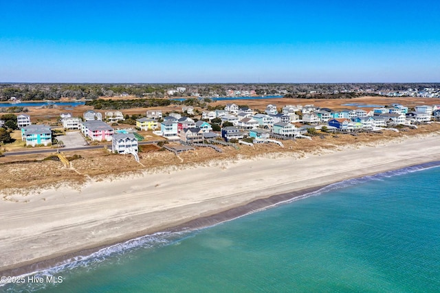 aerial view with a water view and a beach view