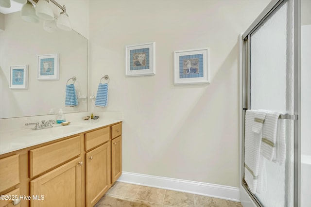 bathroom featuring vanity and a shower with shower door