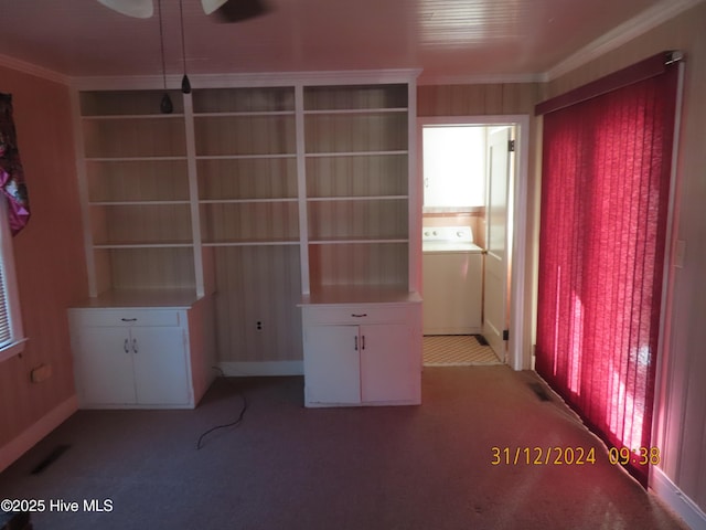 unfurnished bedroom featuring carpet floors, washer / clothes dryer, and crown molding