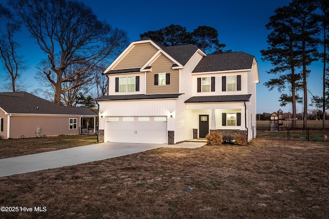 view of front of home featuring driveway, stone siding, an attached garage, fence, and a front lawn