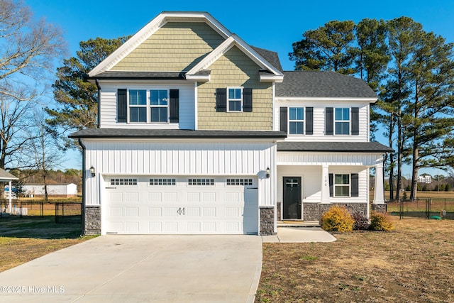 craftsman inspired home featuring a garage and a front yard