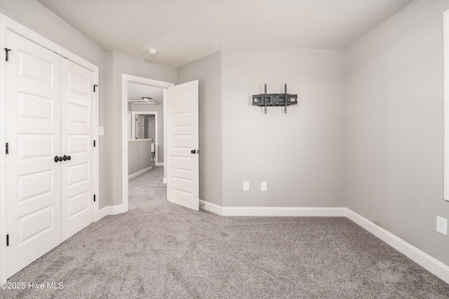 unfurnished bedroom with a closet and carpet