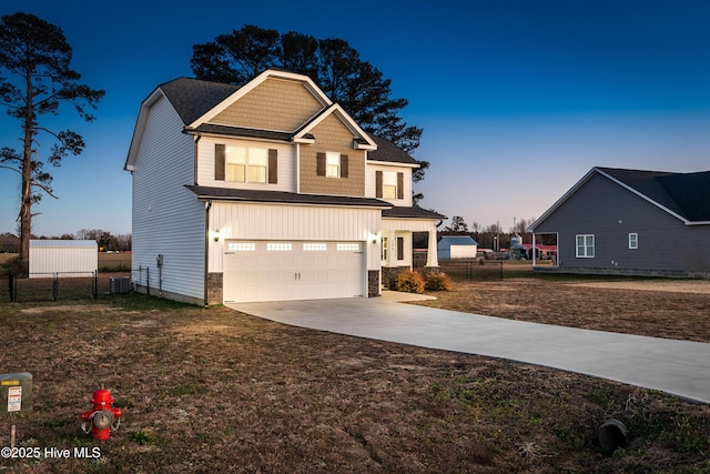 craftsman-style house featuring stone siding, concrete driveway, cooling unit, an attached garage, and fence