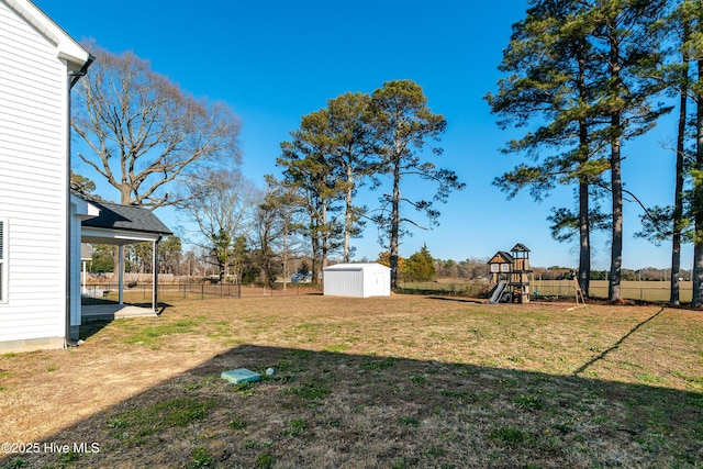 view of yard featuring a playground and a shed